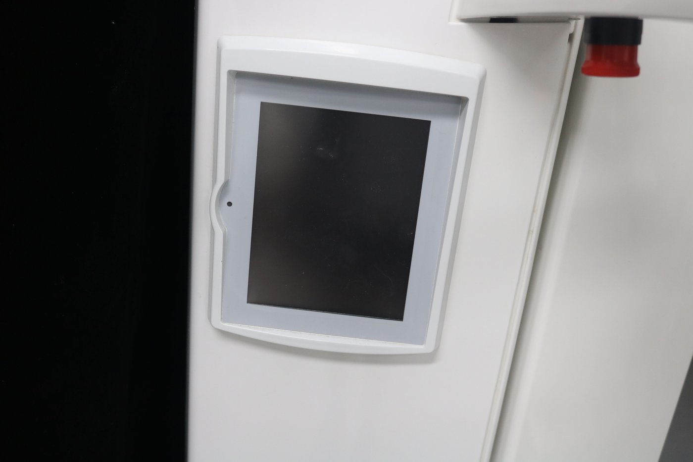 ProOne brand logo etched on the white column of the Planmeca panoramic X-ray machine