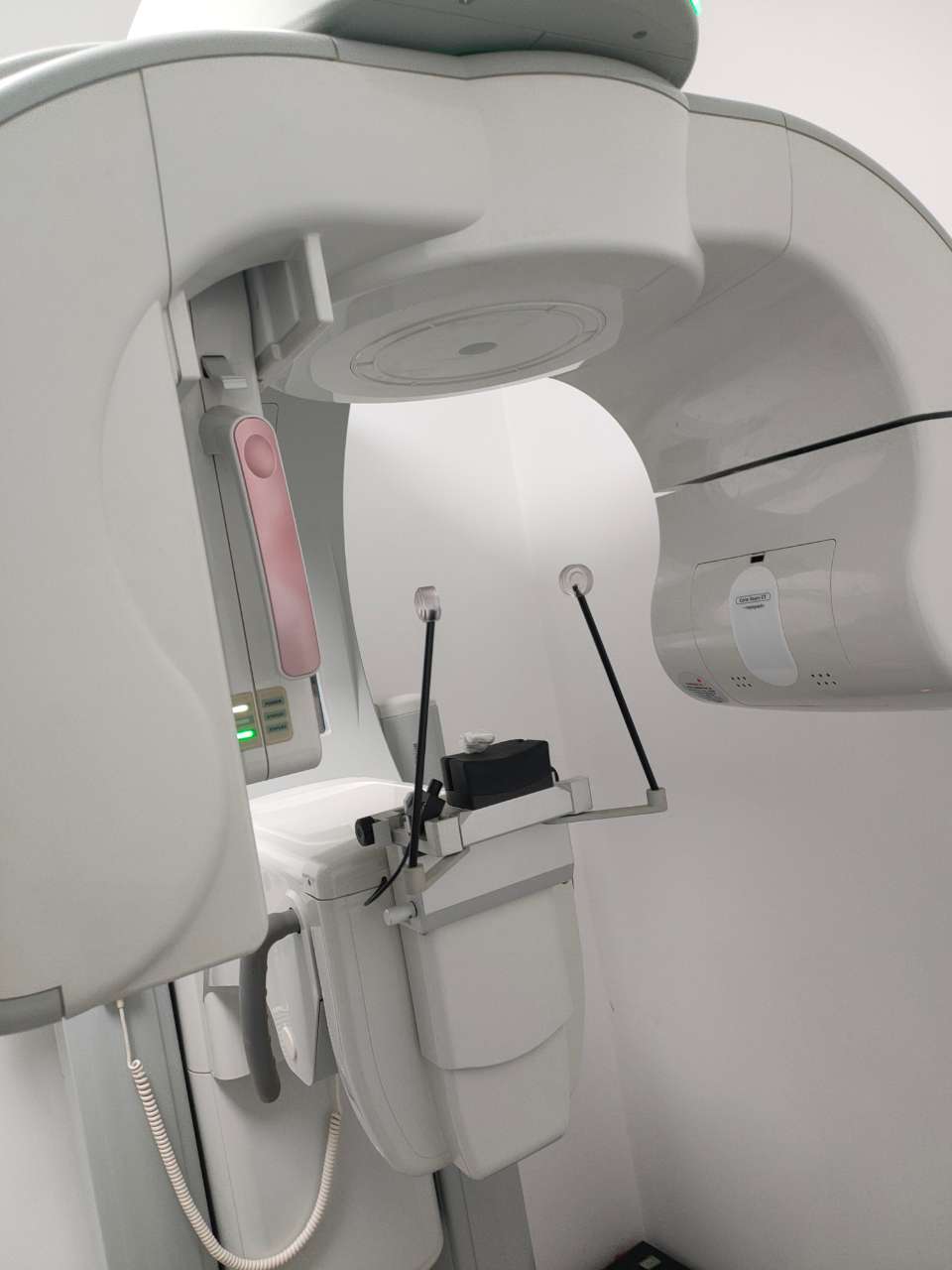 VATECH Implagraphy CBCT interior — patient positioning area with pink forehead rest, chin rest, bite block and temple supports